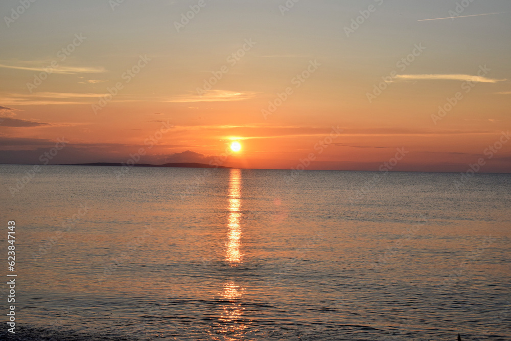 Beautiful sunset over the sea on a hot summer day