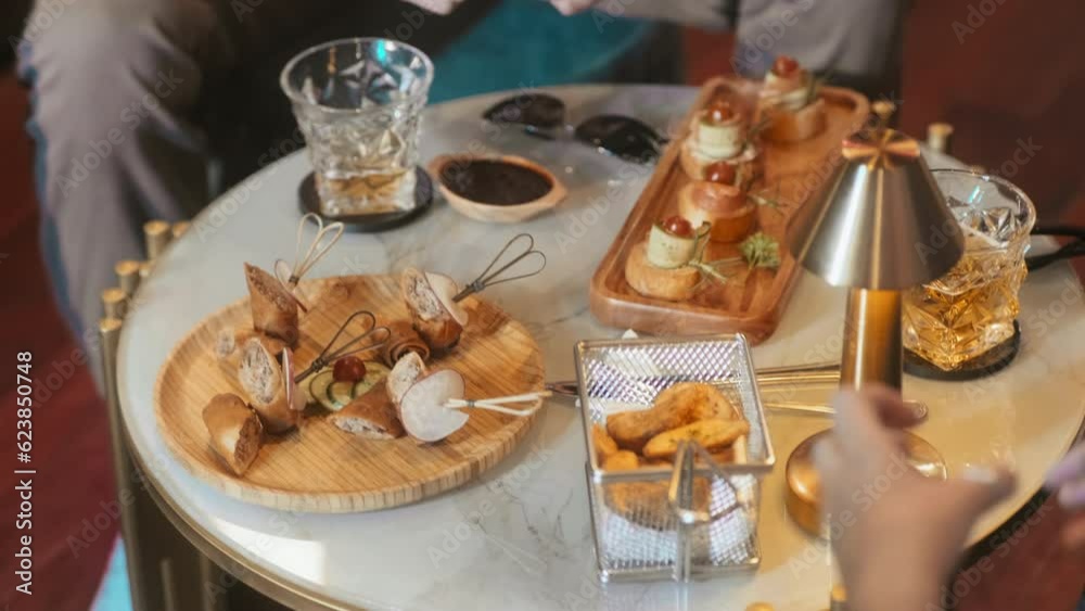High angle view of table with set of snacks for company at friends party in night club High angle view of table with set of snacks for company at friends party in night club