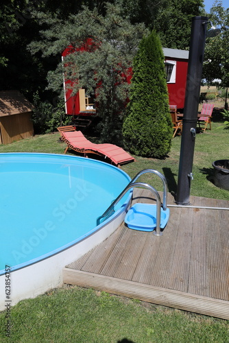 a red trailer with a lounger by the pool