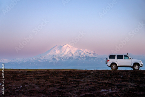 White car in fron of snow mountain