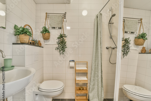 a bathroom with plants on the wall and toilet in the corner  as seen from the shower stall to the right