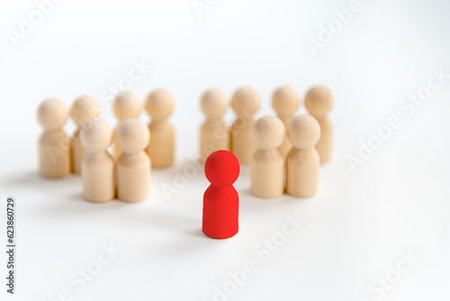 Leadership concept with a wooden dolls. Outstanding wooden dolls in front of others. Selection of teams, the appointment of a leader.
