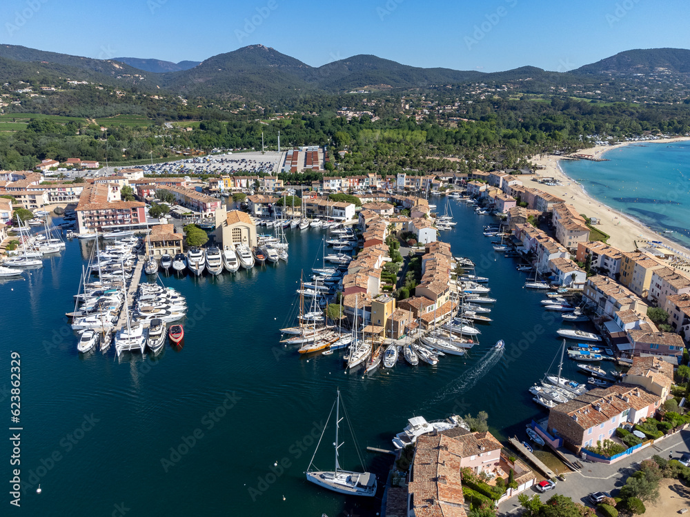 Arial view on blue water of Gulf of Saint-Tropez, boats, houses in Port Grimaud and Port Cogolin, villages on Mediterranean sea with yacht harbour, Provence, summer vacation in France