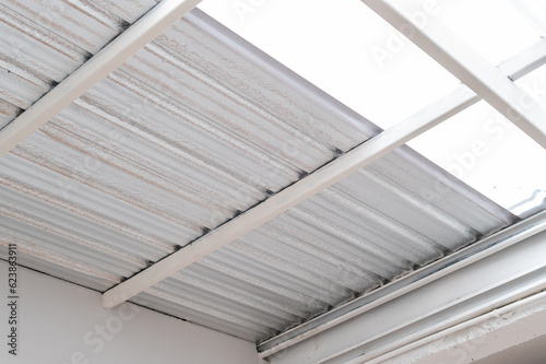 industrial grade metal roof insulation. heat resistant sheet foil provides thermal protection and energy efficiency. corrugated design and silver texture add modern and abstract touch to construction.