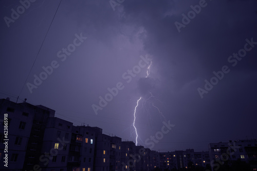 lightning in the city struck behind a high-rise building