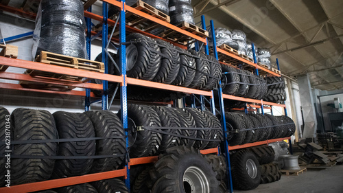 Brand new big variety of car's tyres on shelf in warehouse.
