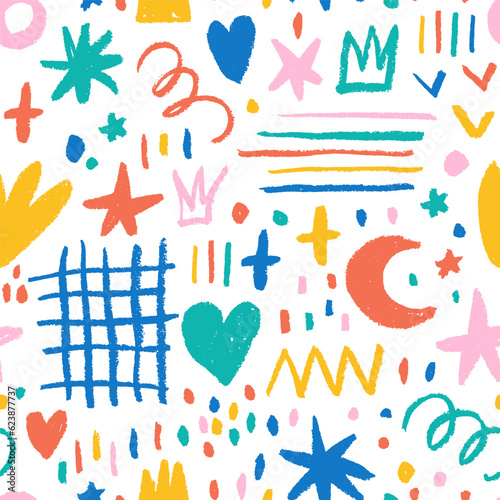 Fun colorful doodle shapes seamless pattern. Childish style charcoal drawing. Hand drawn abstract squiggles, crowns, grid, stars and dots. Multi colored doodle background for kids.