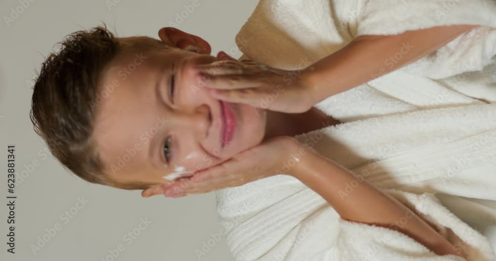 handsome cute teenager boy washing his face from foam after shaving process, washing procedures in the morning Slow motion Vertical view morning hygiene shampoo foam on face, cleaned in bathroom handsome cute teenager boy washing his face from foam after shaving process, washing procedures in the morning Slow motion Vertical view morning hygiene shampoo foam on face, cleaned in bathroom