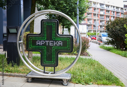 luminous signboard pharmacy near the pharmacy in Poland "Apteka"