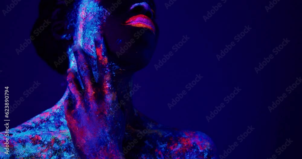 beautiful african sensual woman in neon UF light looking aside. attractive young model girl with fluorescent creative psychedelic make-up, body-art Beauty concept beautiful african sensual woman in neon UF light looking aside. attractive young model girl with fluorescent creative psychedelic make-up, body-art Beauty concept