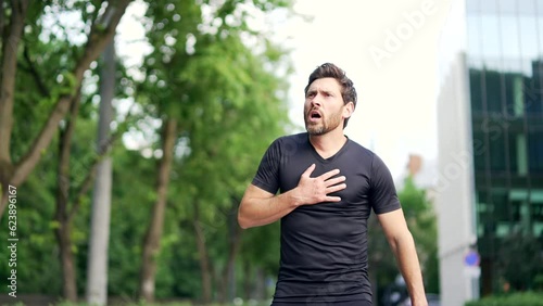 A man is running on a track when he suddenly starts to experience chest pain. He stops running and clutches his chest. The pain is severe and he struggles to breathe. heart attack, shortness of breath