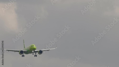 Jet airplane approaching landing at Tolmachevo airport, front view. Passenger plane flies. Travel aviation concept photo