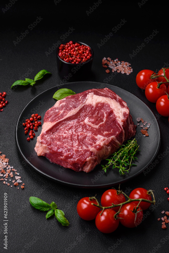 Fresh, raw beef steak with salt, spices and herbs