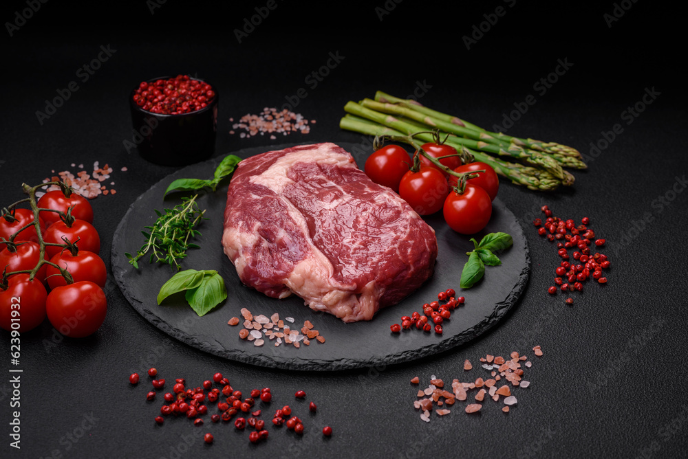 Fresh, raw beef steak with salt, spices and herbs Fresh, raw beef steak with salt, spices and herbs