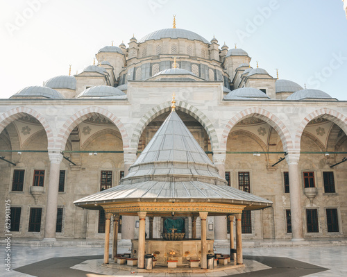 Fatih Mosque or Conqueror's Mosque in Istanbul, Turkey. Beautiful Fatih camii is landmark of Istanbul. Panorama of mosque courtyard, old muslim Turkish architecture. Travel, culture and tourism theme photo