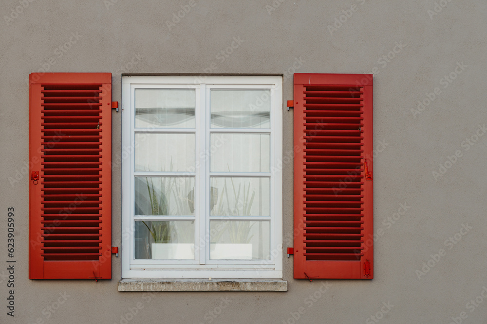 Italian windows on the grey wall facade with open red color classic shutters. window shutter wall europe Italian windows on the grey wall facade with open red color classic shutters. window shutter wall europe