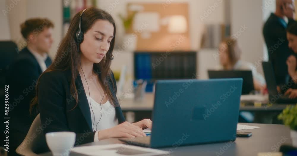 Businesswoman showing data on video call in office. Businesswoman showing data on video call in office.