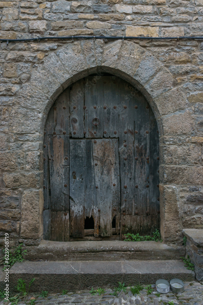 old door in a street of medieval village Ainsa in the spanish pyrenees, Huesca, Aragon, Spain