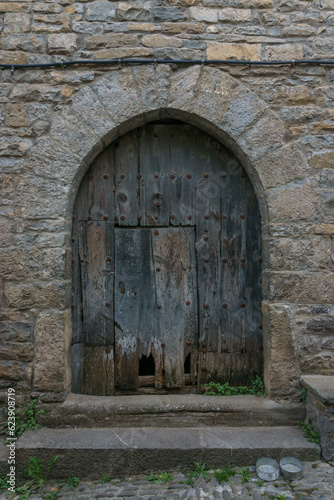 old door in a street of medieval village Ainsa in the spanish pyrenees, Huesca, Aragon, Spain