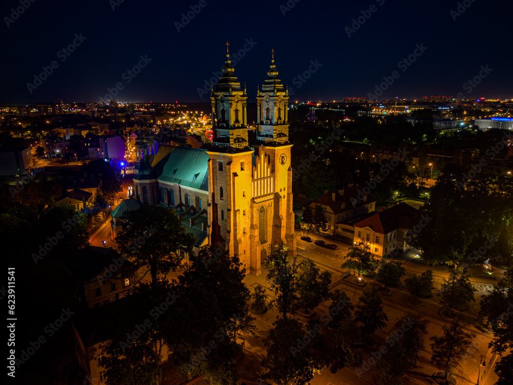 Aerial drone view of Cathedral Basilica of Saints Peter and Paul in Poznan Ostrow Tumski in night