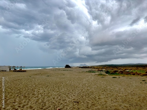 dark thunderstorm clouds over the beach near Sotogrande with the Rockmof Gibraltar at the horizon, storm, rain, drought, Andalusia, Cadiz, Malaga, Spain