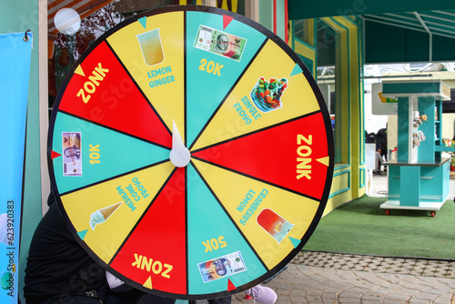 The wheel of fortune hung up in front of cafe restaurant. Spinning door prize concept. 