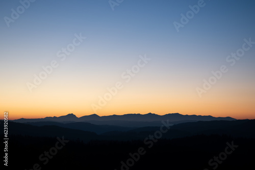 sunrise over the silhouette of the mountains