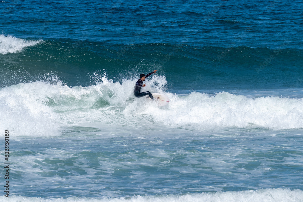 Surfer riding waves in Furadouro Beach Surfer riding waves in Furadouro Beach