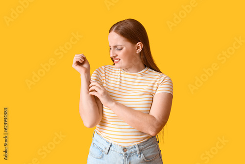 Allergic young woman scratc...