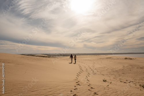 Two womens walks through the dunes of the Cabo Polonia National Park in the Department of Rocha in Uruguay
