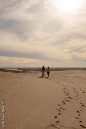 Two womens walks through the dunes of the Cabo Polonia National Park in the Department of Rocha in Uruguay