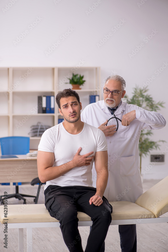 Obraz premium Young male patient visiting old male doctor