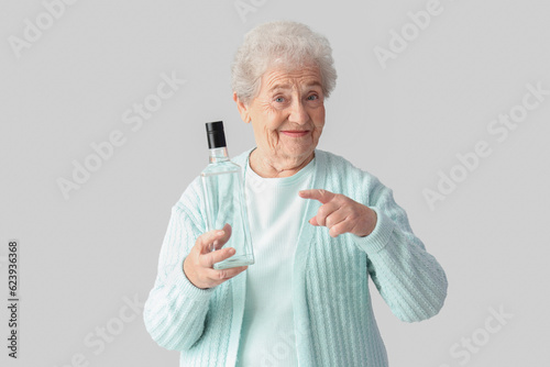Senior woman pointing at bo...