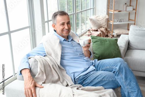 Mature man drinking tea on his day off at home