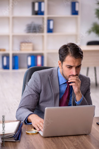 Young male employee working in the office