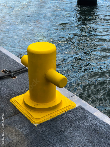 Yellow color bollard on the dock