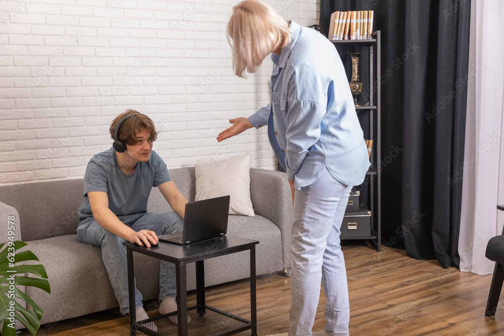 addiction. Woman scolding her son while he using laptop in(02)