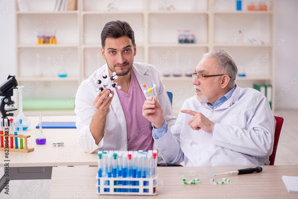 Two male chemists working at the lab Two male chemists working at the lab
