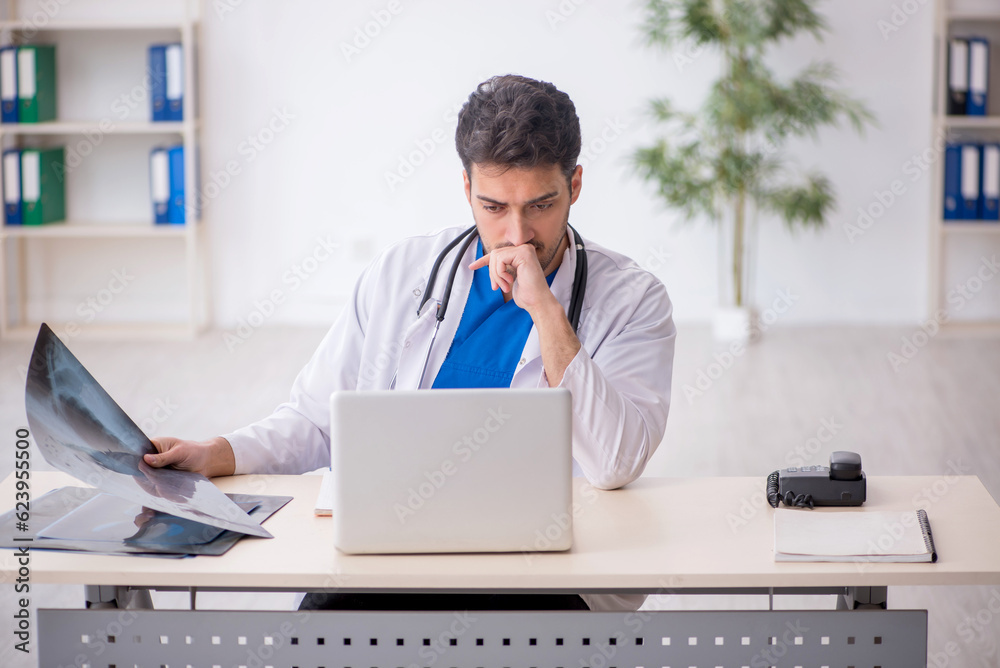 Fototapeta premium Young male doctor radiologist working in the clinic