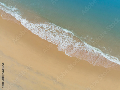 Beach Wave water in the Tropical summer beach with white sand beach background