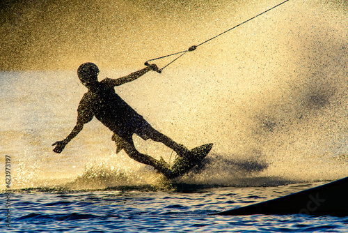 wakeboarder on a lake, waterski cable lift photo