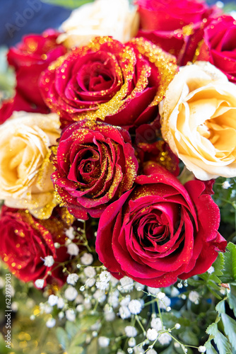 bouquet of red and white roses with gold glitter.