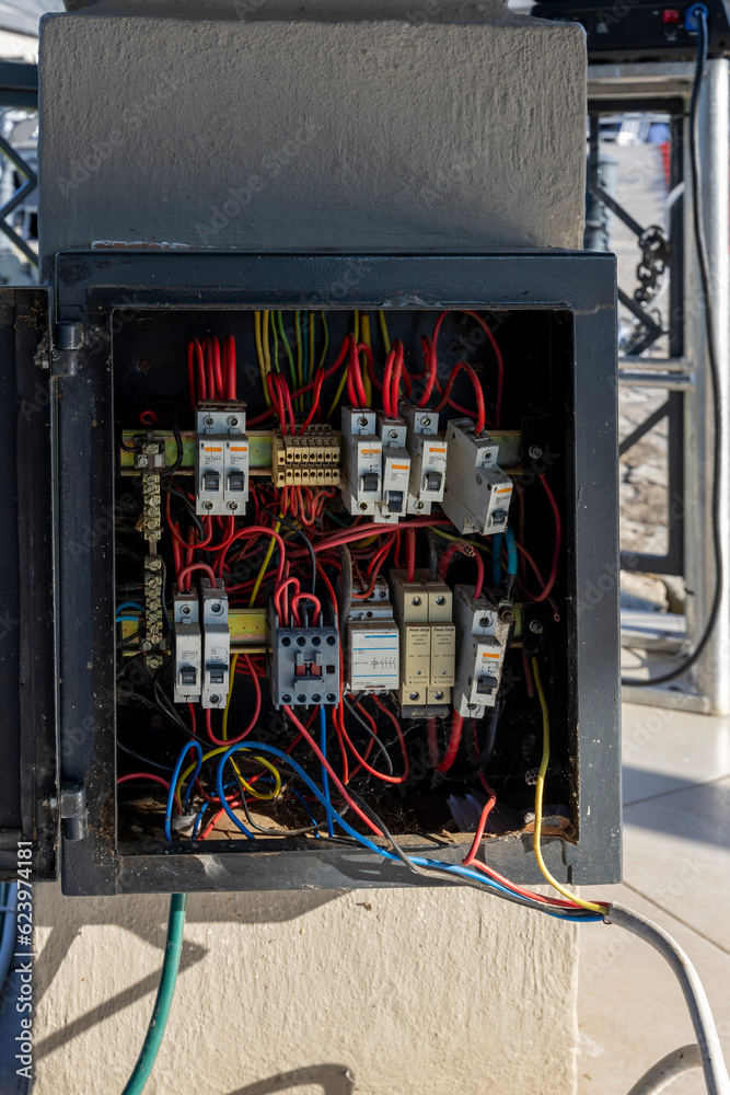 unsafe electric panel with power arrestors and breakers, wrongly wired, and cables exposed unsafe electric panel with power arrestors and breakers, wrongly wired, and cables exposed