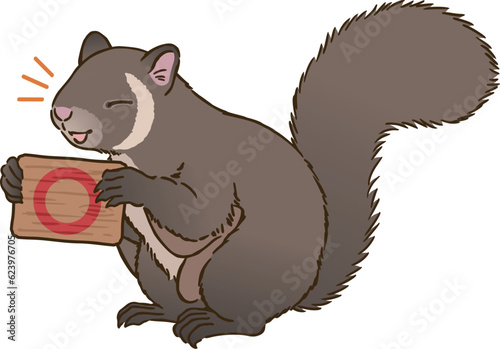 丸マークを描いた看板を持つムササビ