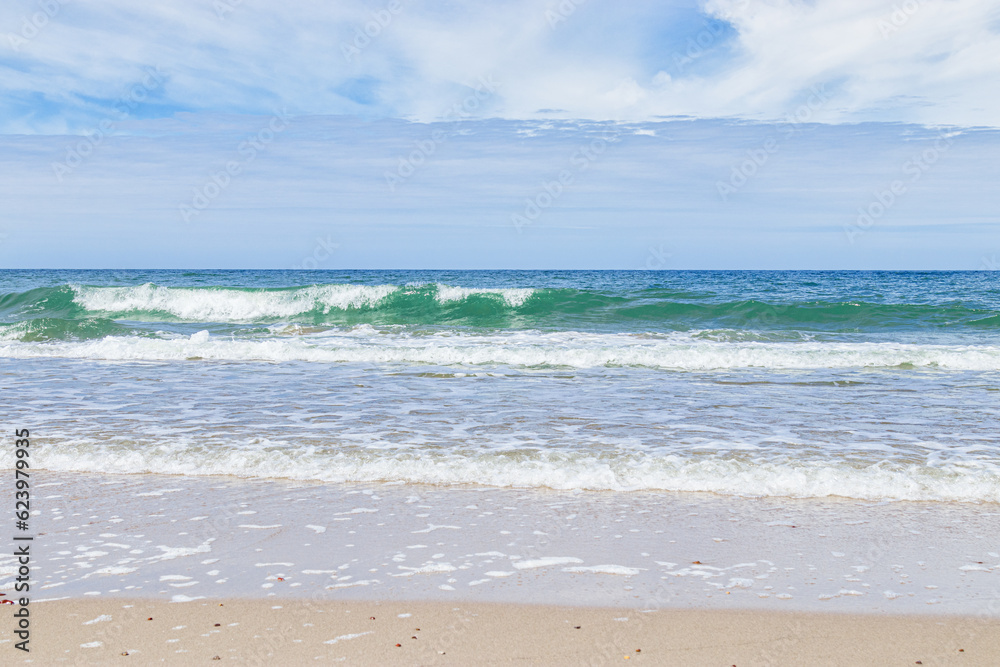 Beautiful tropical beach with blue sky with clouds as abstract nature background. Scenic landscape with sparkling waves ocean, aesthetic beauty nature. Summer day on Baltic sea, Curonian spit.