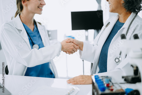 Doctor  handshake and partnership in healthcare  medicine or trust for collaboration  unity or support.Team of medical experts shaking hands in teamwork for or success in clinic or hospital