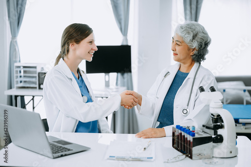 Doctor handshake and partnership in healthcare  medicine or trust for collaboration  unity or support.Team of medical experts shaking hands in teamwork for or success in clinic or hospital.