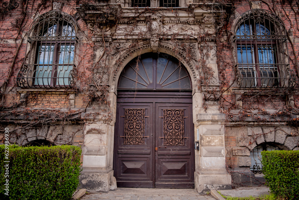 Facade of a old european historical building with vintage windows and doors