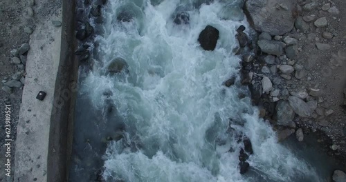 Beautiful river of Gilgit baltistan Pakistan drone footage of beautiful river flowing producing white foam rotatory motion footage  photo