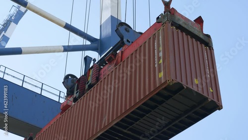 4K actual cam footage of crane port lifting down red container on cargo trailer stock video.  photo